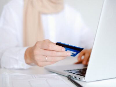 person in white long sleeve shirt holding credit card